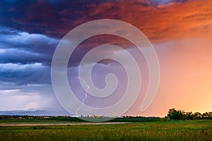 Dramatic sunset thunderstorm lightning bolt