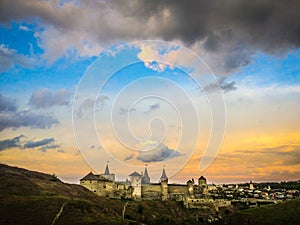 Dramatic sunset view on the castle in Kamianets-Podilskyi in spring.