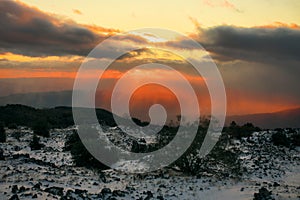 Dramatic Sunset On Volcanic Rock With Snow