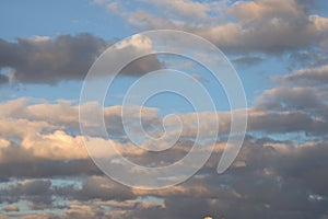 Dramatic thunder clouds against the blue sky on a sunset. Cloudscape