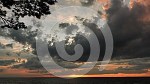 Dramatic thunder clouds at sunset sky