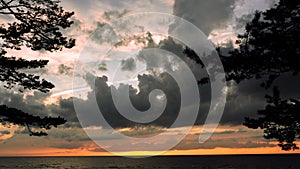 Dramatic thunder clouds at sunset sky