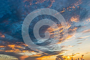 Dramatic twilight sky with orange clouds at sunset