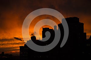 Dramatic Urban Sunset in New York City silhouette