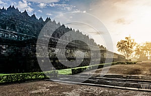 Dramatic view of ancient stupa borobudur temple with ray sunrise in the morning. the world`s largest Buddhist temple and UNESCO