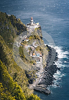 Dramatic view down to lighthouse on Ponta do Arnel, Nordeste, Sao Miguel Island, Azores, Portugal