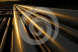 Dramatic view of golden steel pipes in oil refinery