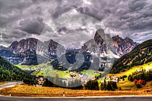 Dramatic view of the Italian Alps and the city of Corvara, Italian Dolomites