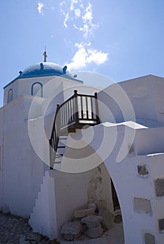 Dramatic view of an old Greek church with a blue dome.