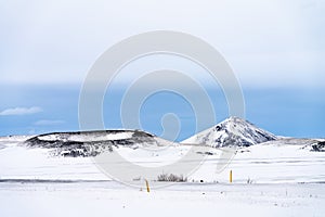 Dramatic volcanic landscape with snow covered crater near lake Myvatn, Iceland