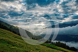 dramatic weather mood in the mountains. Green lush meadows, davos graubunden swiss