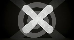 Dramatic white X symbol projected on concrete wall