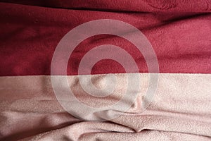 Draped artificial suede fabric in pink and red