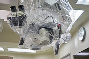 A draped surgical microscope in operating room