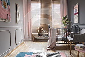 Drapes and blinds on windows in child`s bedroom interior with pi