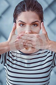 Drastic dark-haired female crossing palms expressing protestation