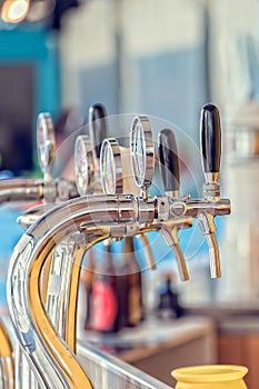Draught beer taps in a bar.