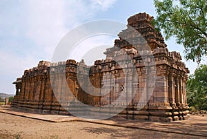 Dravidian vimana style sikhara and a view of the Devakoshthas on the south wall. Jain temple, Jinalaya, known as Jaina Narayana, P