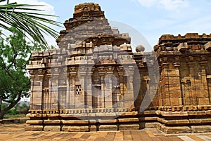 Dravidian vimana style sikhara and a view of the Devakoshthas on the south wall. Jain temple, Jinalaya, known as Jaina Narayana, P