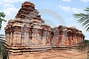 Dravidian vimana style sikhara and a view of the Devakoshthas on the south wall. Jain temple, Jinalaya, known as Jaina Narayana, P