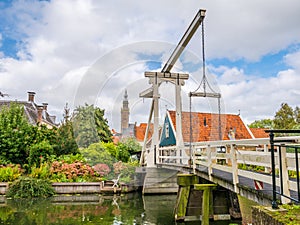 Draw bridge Kwakelbrug over canal and bell tower in Edam, Noord-Holland, Netherlands