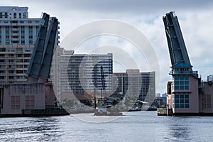 Draw bridge opening to let crane on barge go underneath