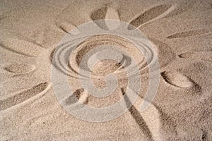 Draw of a sun on sand