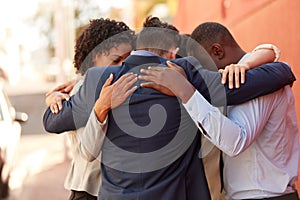 We draw support and motivation from each other. Shot of a group of businesspeople standing together in a huddle outdoors