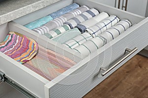 Drawer with folded towels. Order in kitchen