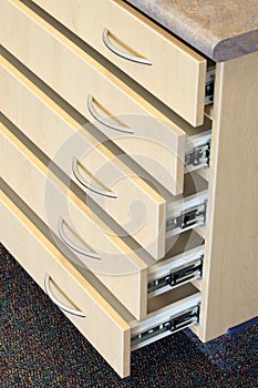 Drawer fronts with pulls and drawer slides. photo