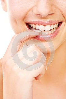 Drawing attention to her radiant smile. Studio shot of a beautiful young woman with perfect skin isolated on white.