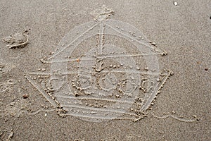 A drawing a boat in the sand on beach