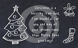 Drawing of christmas tree and handwritten greetings on black chalkboard