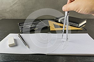 Drawing a circle using a compass in a checkbook.