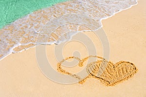 Drawing connected hearts on beach