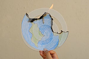 Drawing of the Earth, on fire. The planet is burning in our hands.