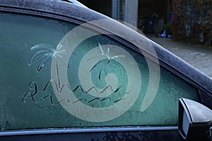 Drawing on frozen car windows on a frosty morning