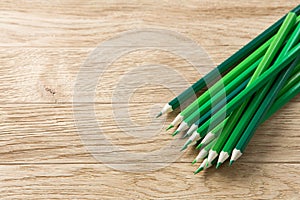 Drawing green pencils on a wooden background