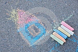 Drawing house with chalk on the asphalt