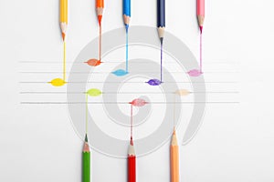 Drawing of musical notes and colorful pencils on background, top view