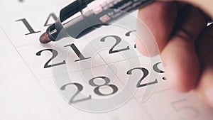 Drawing red circled mark on the twenty-first 21 day of a month in the calendar