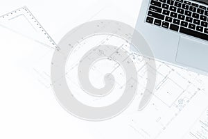 Drawing rulers, and notebook over house construction blueprint w