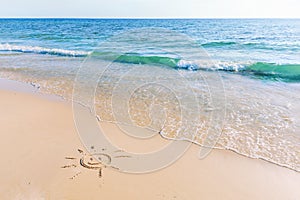 The drawing of the sun on sand beach with soft waves