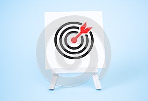 Drawing of a Target an an Arrow on Canvas upon an Easel