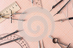 Drawing tools, ruler and protractor on graph paper. Close up