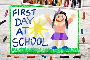 drawing: Words FIRST DAY AT SCHOOL and happy girl.