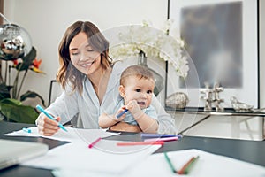 Woman and child drawing with colored felttip pens photo