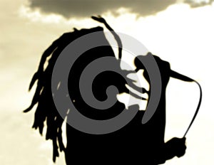 Dreadlock singer silhouette at sunset photo