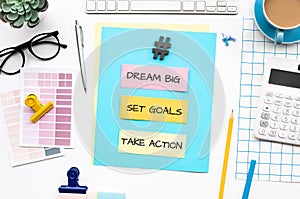 Dream big,set goals,take action concepts with text on desk table