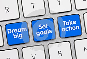 Dream big, Set goals Take action - Inscription on Blue Keyboard Keys